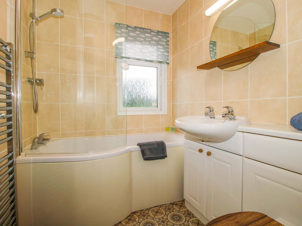 A bathroom with a bathtub, shower, and sink at Dunromin in Montgomery