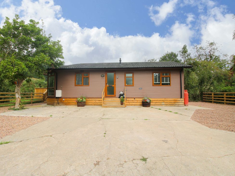 A house with a driveway and plants at Dunromin Montgomery