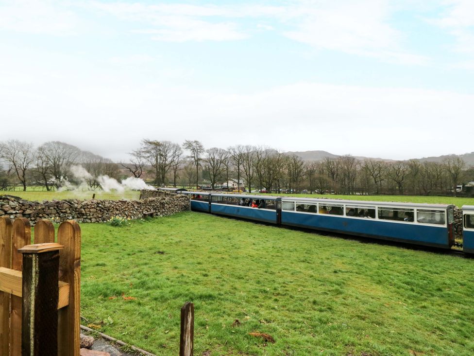 A steam train passing through a countryside area at Dakota in Boot