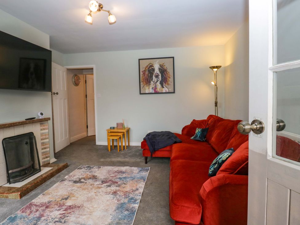 A living room with a sofa and television at Dakota in Boot