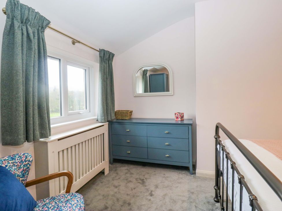 A bedroom with a bed and dresser at Dakota in Boot