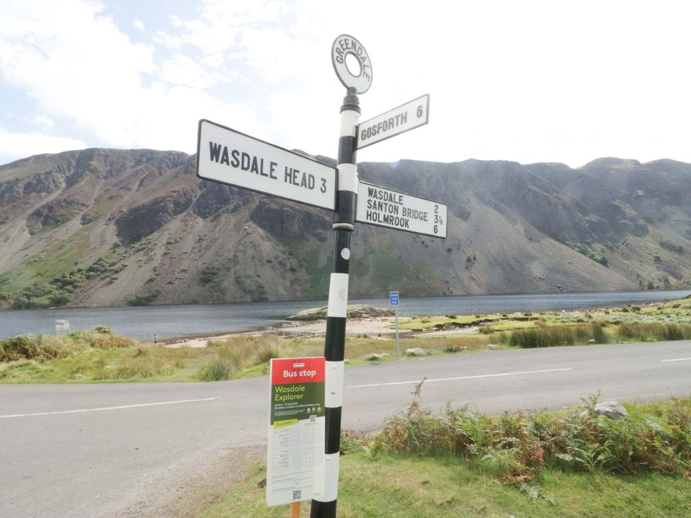 A road sign pointing to various locations near a lake at Dakota in Boot