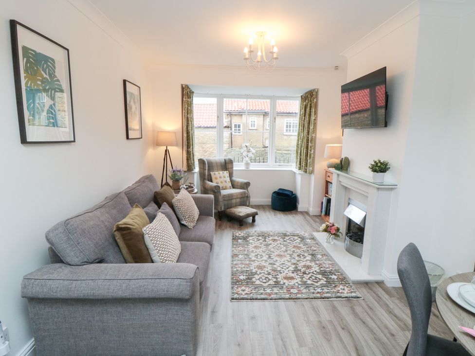 A living room with a sofa and armchair at The Old Chapel in Brompton-By-Sawdon