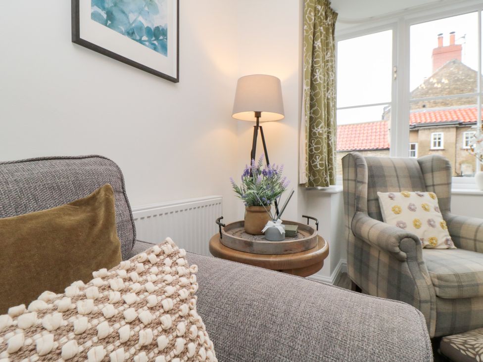 A living room with a sofa and a table in The Old Chapel, Brompton-By-Sawdon