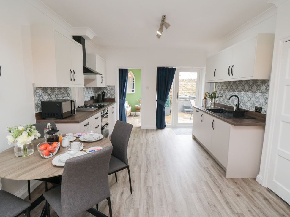 A kitchen with a dining table and chairs at The Old Chapel in Brompton-By-Sawdon