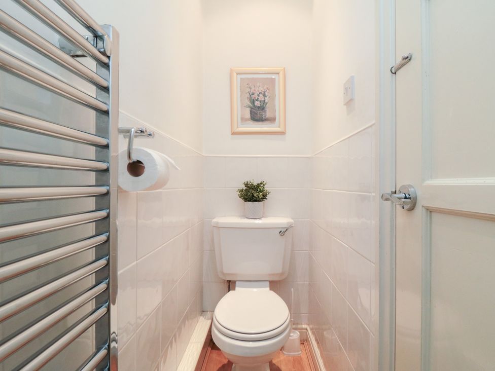 A bathroom with a toilet and towel holder at The Old Chapel in Brompton-By-Sawdon