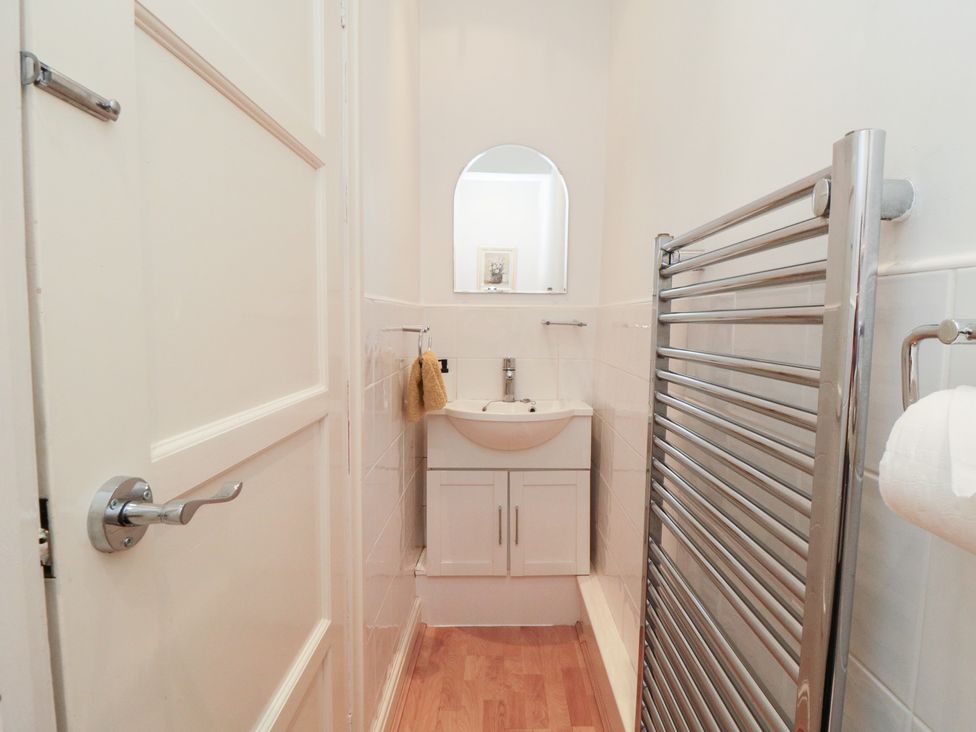 A bathroom with sink and towel rack at The Old Chapel Brompton-By-Sawdon