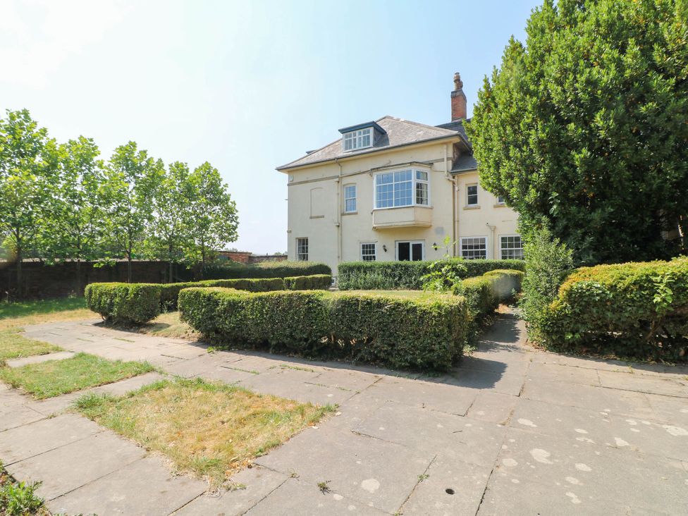 A house with trees and hedges in the garden at Bardon Hill Manor in Coalville