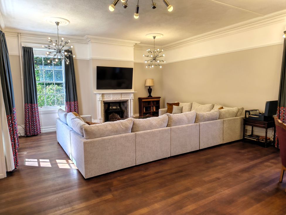 A living room with a sofa and television at Bardon Hill Manor near Coalville