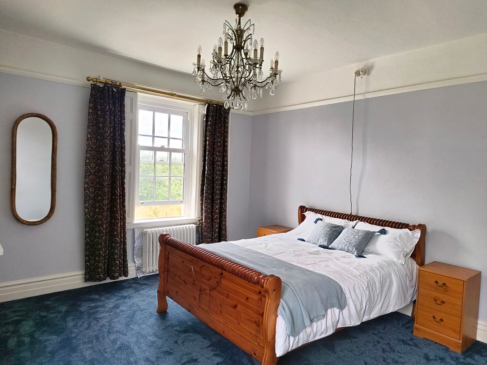 A bedroom with a bed and a mirror at Bardon Hill Manor Bardon Hill near Coalville