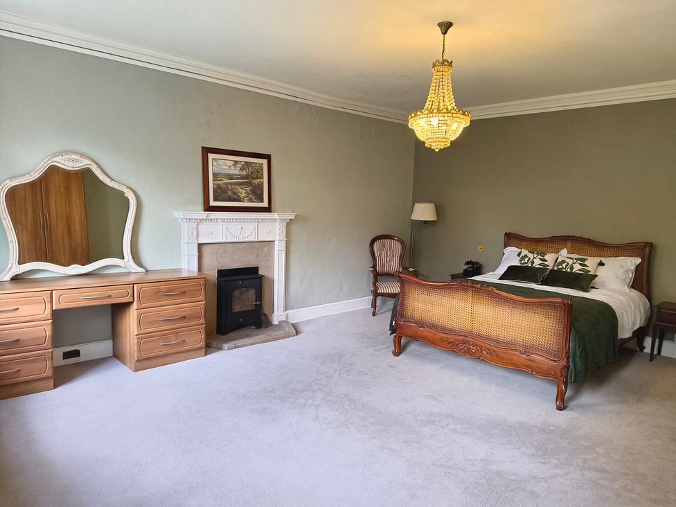A bedroom with a bed and dresser at Bardon Hill Manor Bardon Hill near Coalville