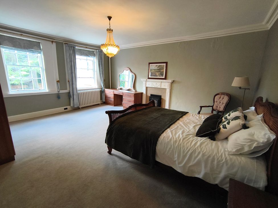 A bedroom with a bed and dresser at Bardon Hill Manor near Coalville