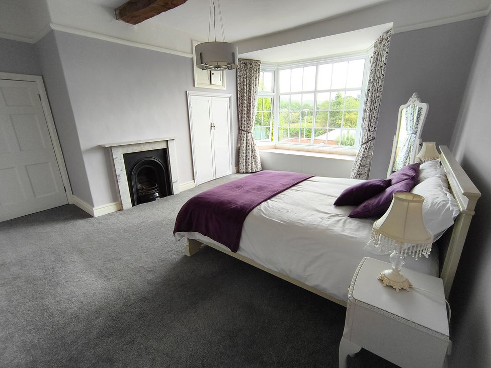 A bedroom featuring a bed with purple blanket at Bardon Hill Manor Bardon Hill near Coalville