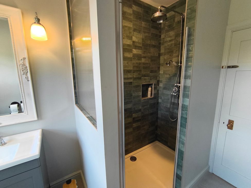 A bathroom with a shower and sink at Bardon Hill Manor near Coalville