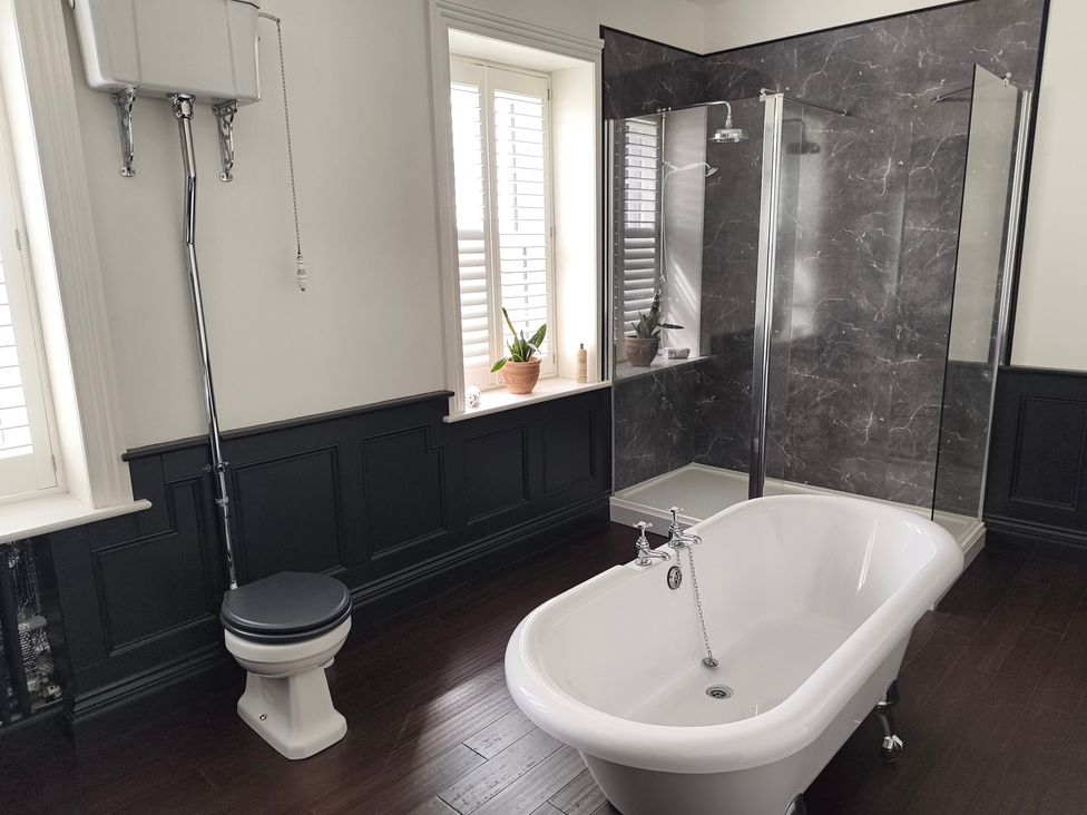 A bathroom featuring a bathtub, toilet, and shower at Bardon Hill Manor near Coalville