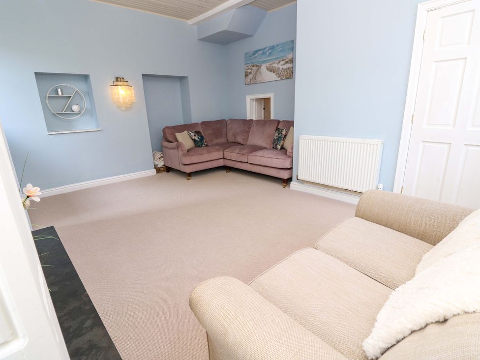 A living room with two sofas and a shelf at Glebe Garth in Chale near Niton
