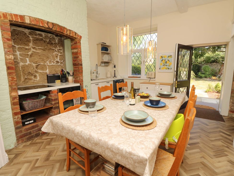 A kitchen with a dining table and chairs at Glebe Garth in Chale near Niton