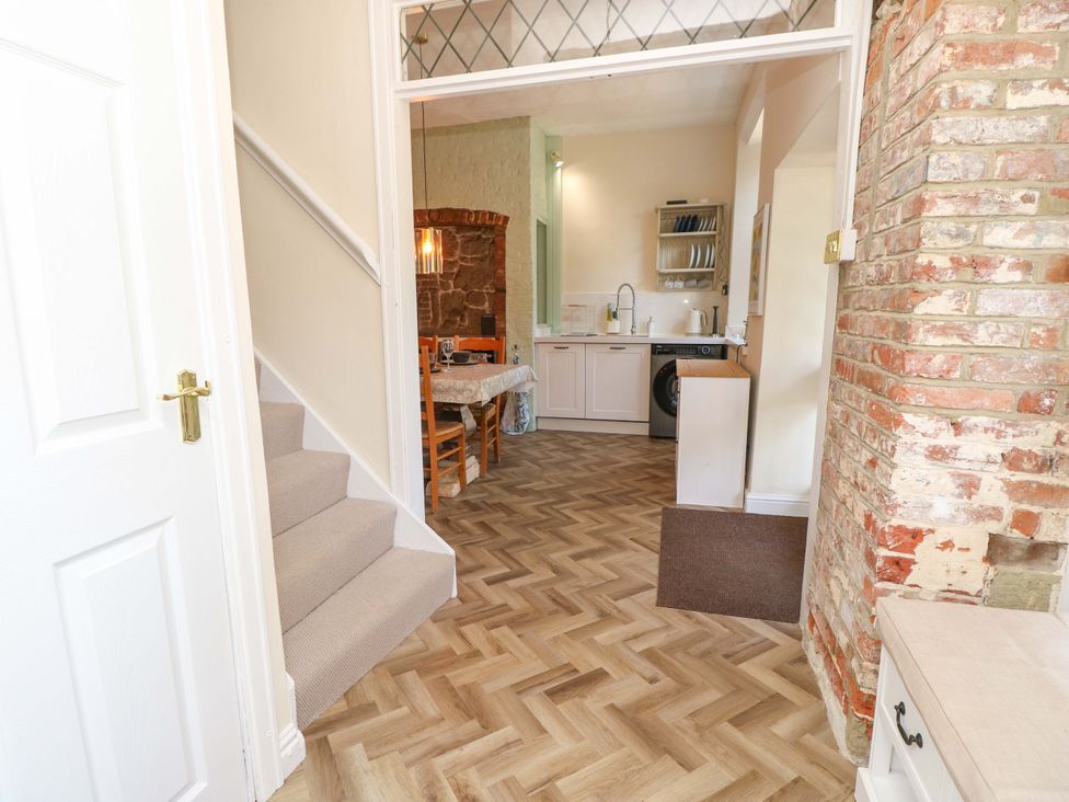 A kitchen with a table and chairs at Glebe Garth in Chale near Niton