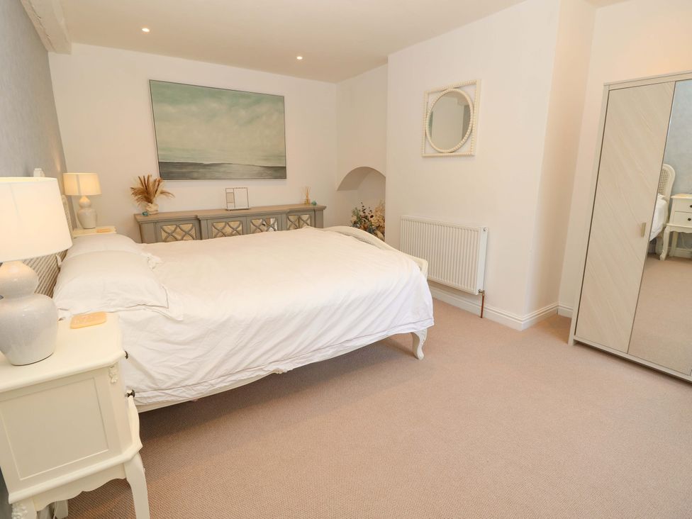 A bedroom with a bed and dresser at Glebe Garth in Chale near Niton