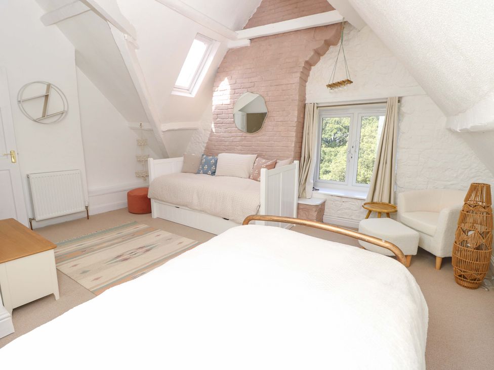 A bedroom with two beds and a window at Glebe Garth Chale near Niton