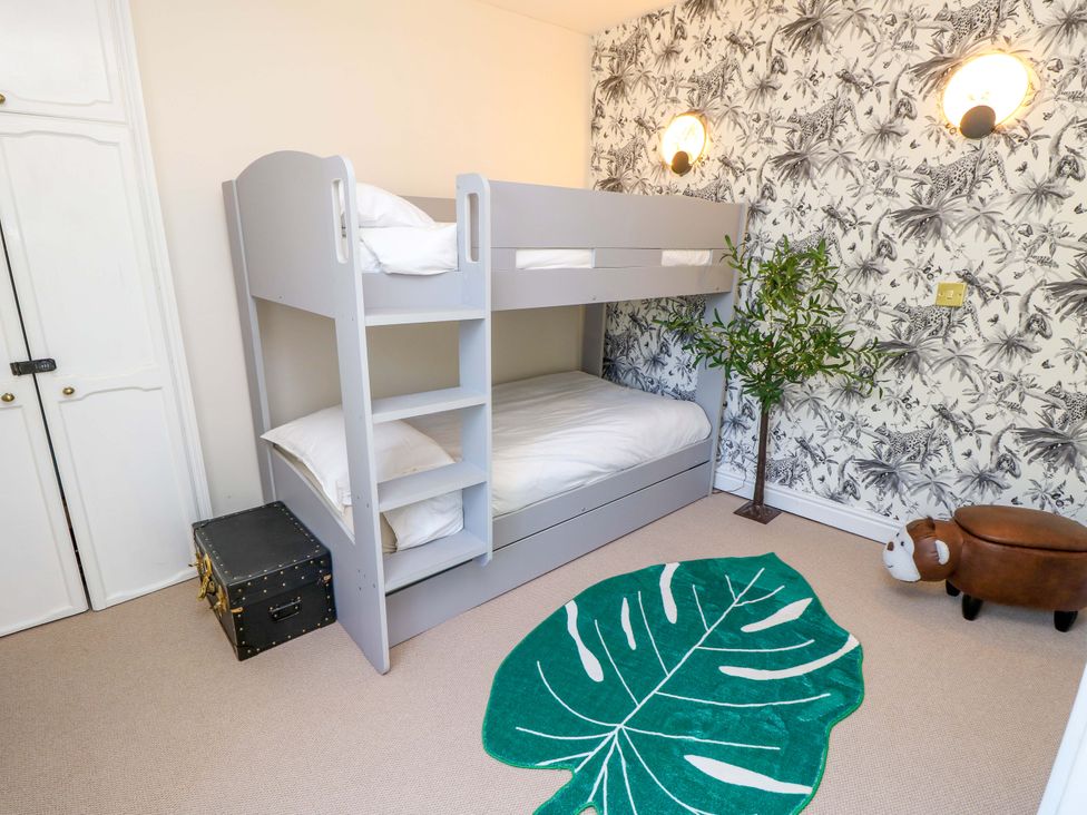 A bunk bed with pillows in a bedroom at Glebe Garth in Chale near Niton