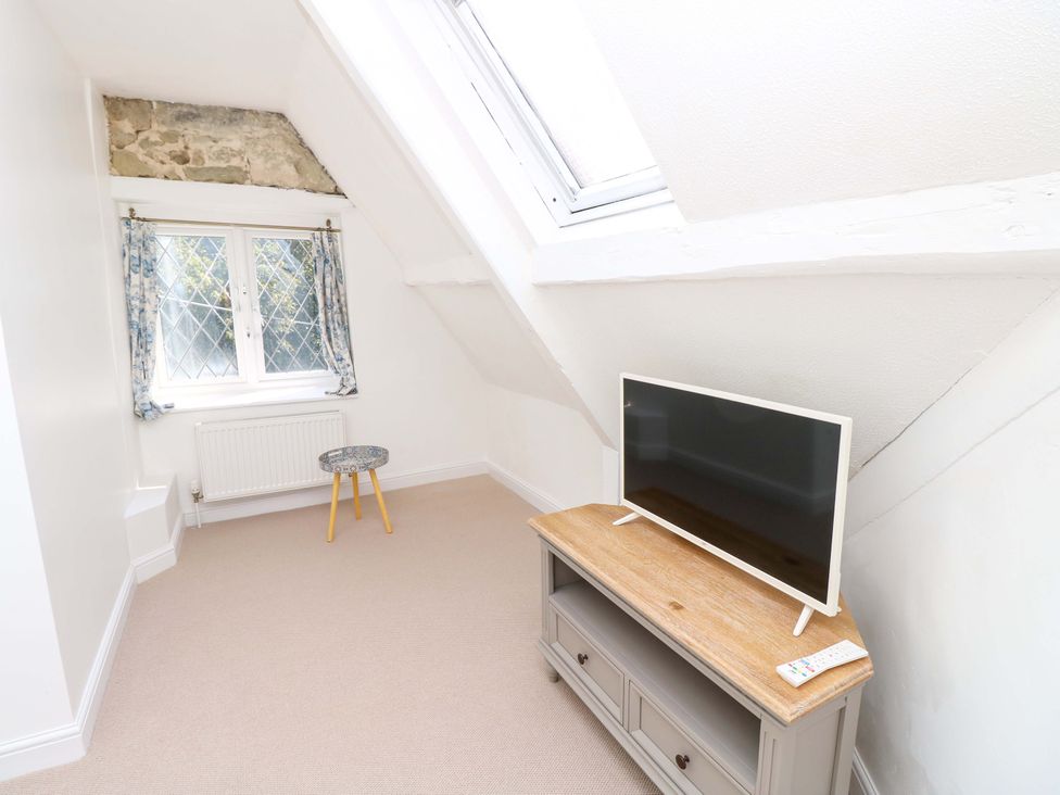 A living room with a television and side table at Glebe Garth in Chale near Niton