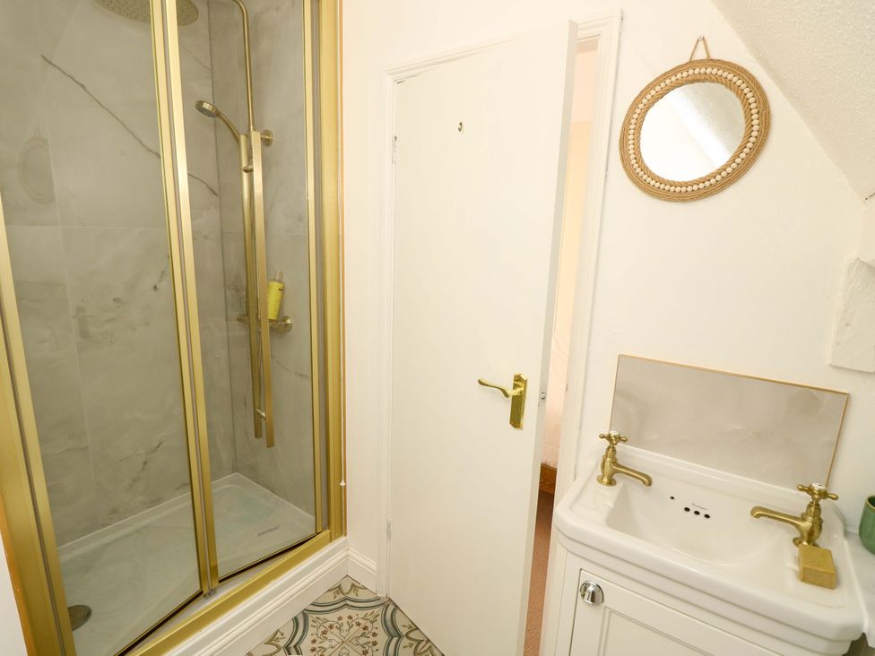 A bathroom featuring a shower and sink at Glebe Garth in Chale near Niton