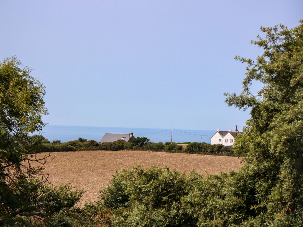 A landscape view with a house near the ocean at Glebe Garth in Chale near Niton