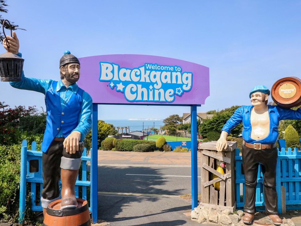 A welcome sign with statues at Blackgang Chine near the coast