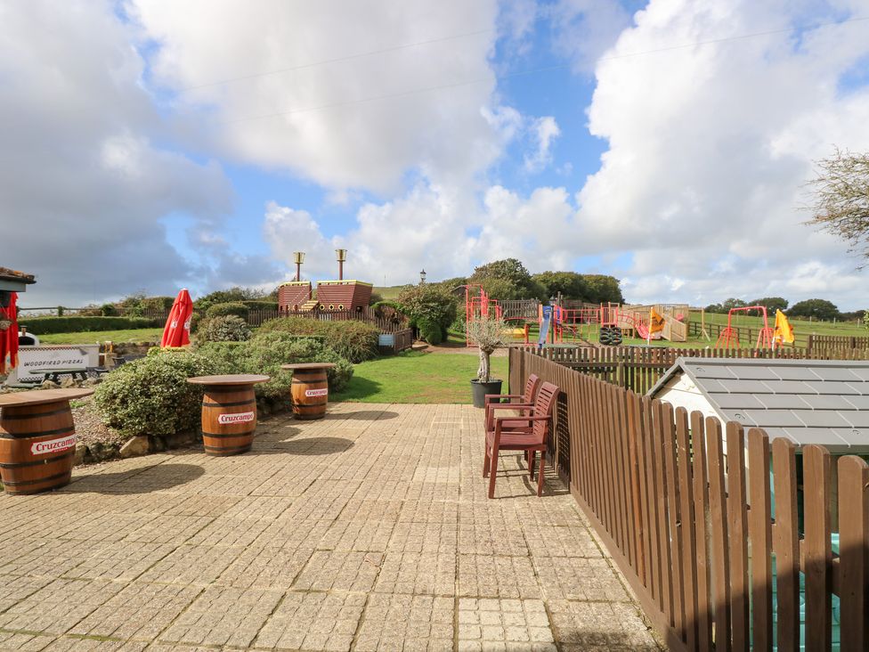 A garden area with a playground and seating at Glebe Garth in Chale near Niton