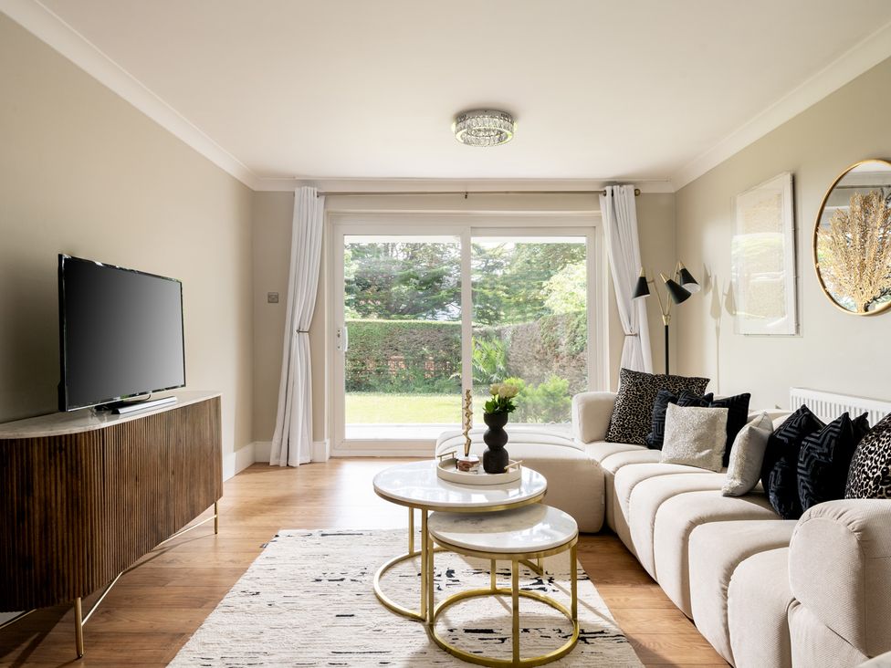 A living room with a television and sofa at Seaheaven