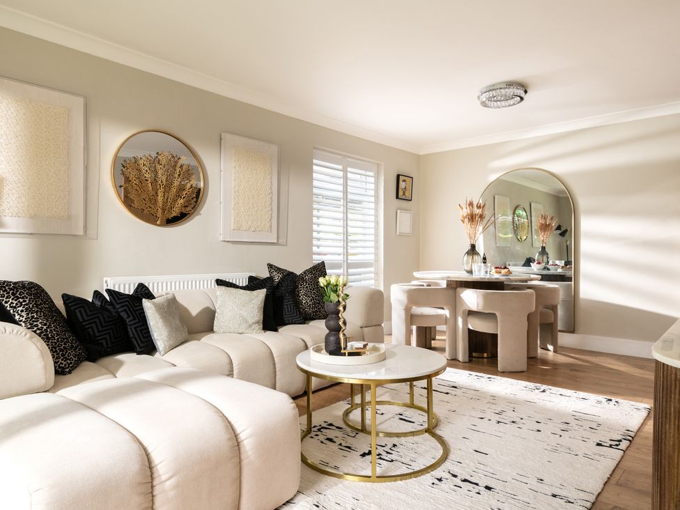 A living room with a sofa, coffee table, and dining area at Seaheaven