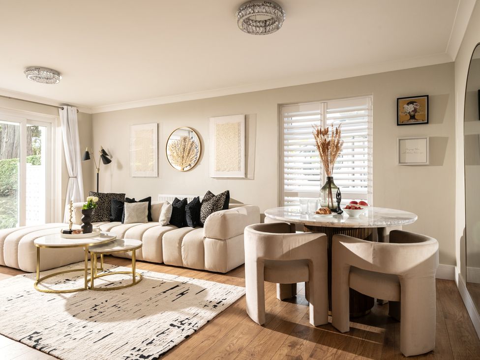 A living room with a sofa and dining table at Seaheaven