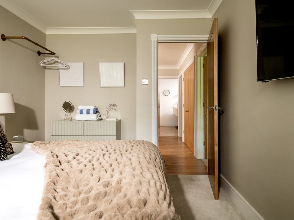 A bedroom with a bed and a door at Seaheaven