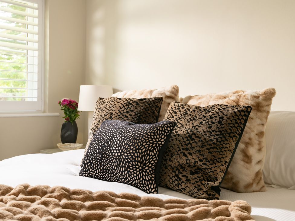 A bedroom with pillows and a lamp at Seaheaven