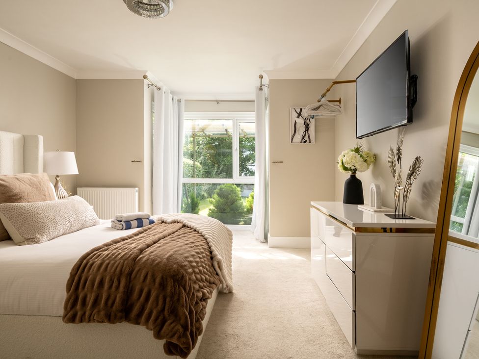 A bedroom with a bed and television at Seaheaven