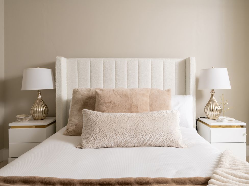 A bed with pillows and lamps at Seaheaven