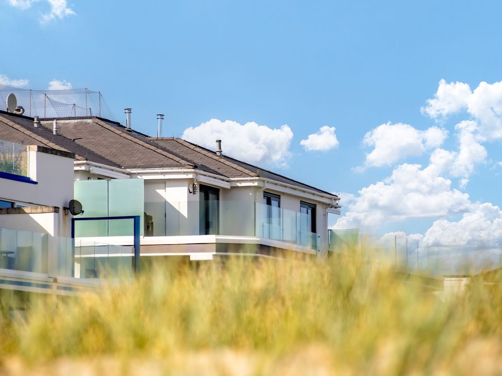 A view of a building with balconies under a blue sky at Seaheaven