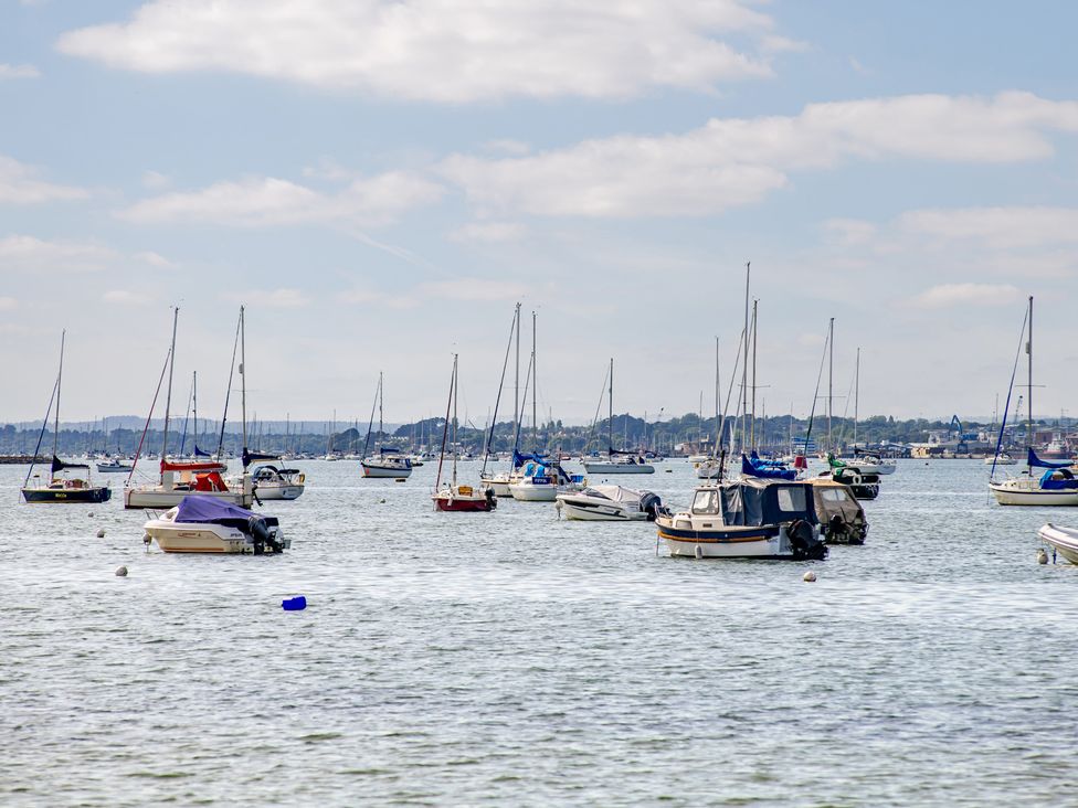 Sailboats moored on water with a blue sky at Seaheaven