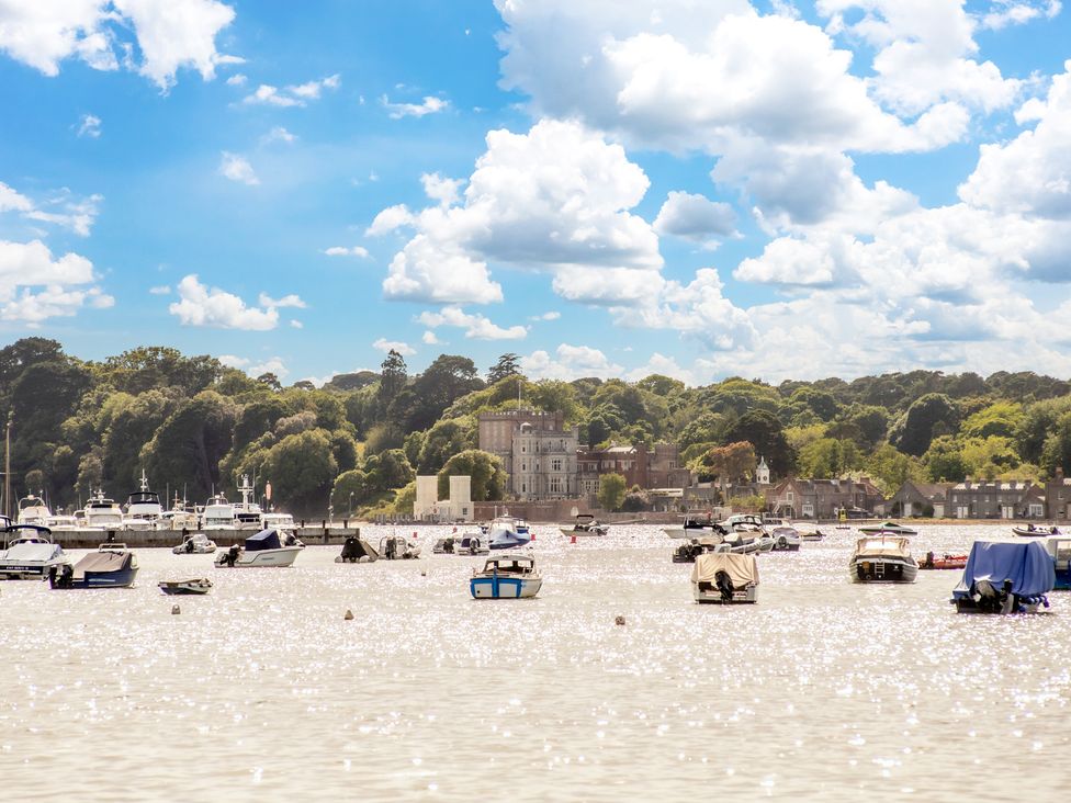 A view of boats on water with buildings and trees in the background at Seaheaven
