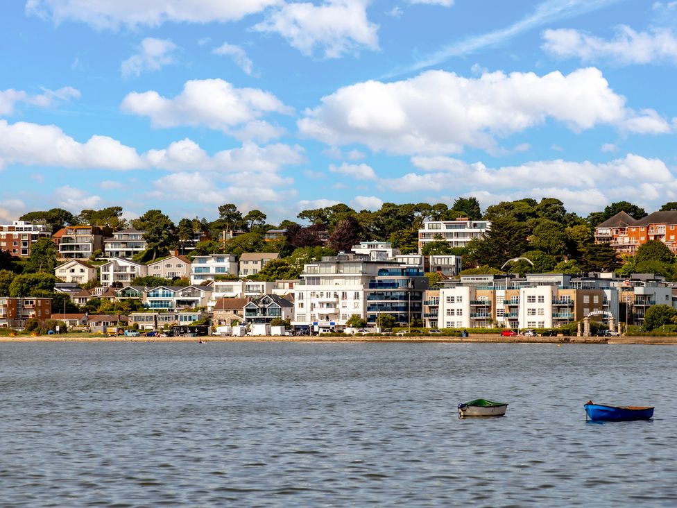 A view of buildings along a waterfront with boats at Seaheaven