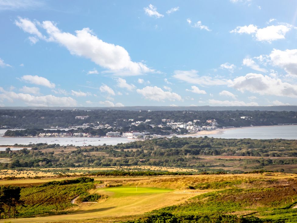 A golf course overlooking a beach and buildings at Seaheaven