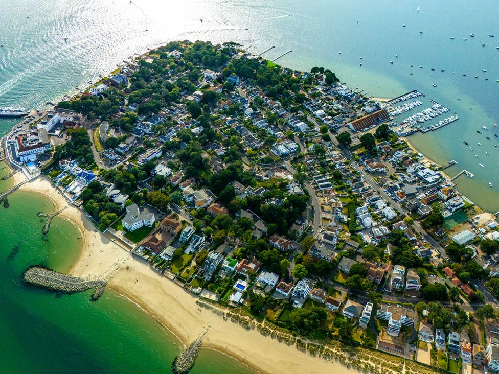 An aerial view of a coastal town with houses and a marina at Seaheaven