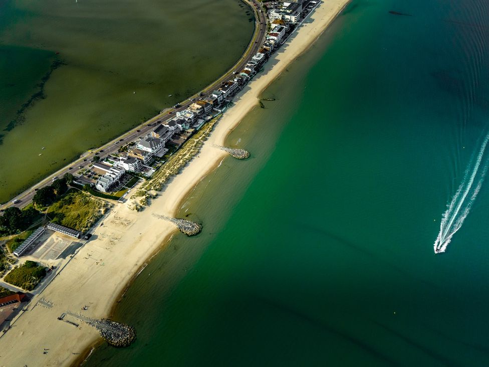 An aerial view of a beach with buildings and water at Seaheaven