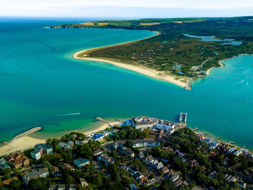 An aerial view of a coastline with beach and nearby buildings at Seaheaven