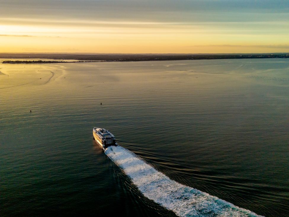 A ferry traveling on water during sunset at Seaheaven