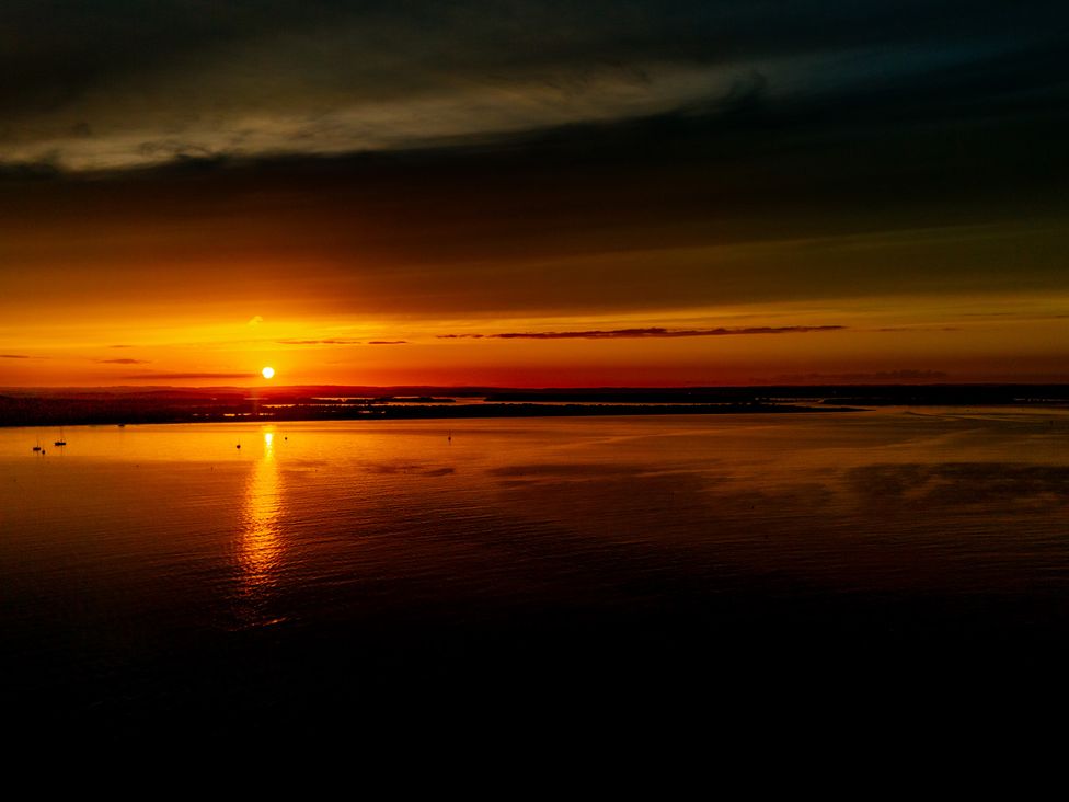 A sunset over water with reflections at Seaheaven