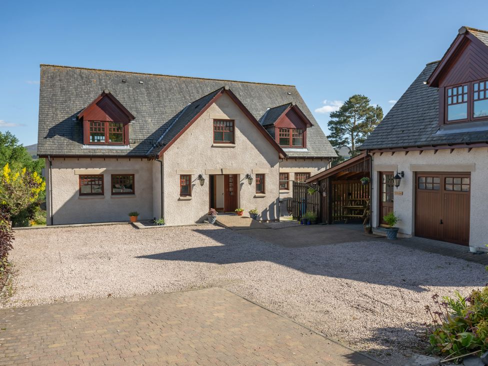 A house with a garage and driveway at Old Distillery Lodge