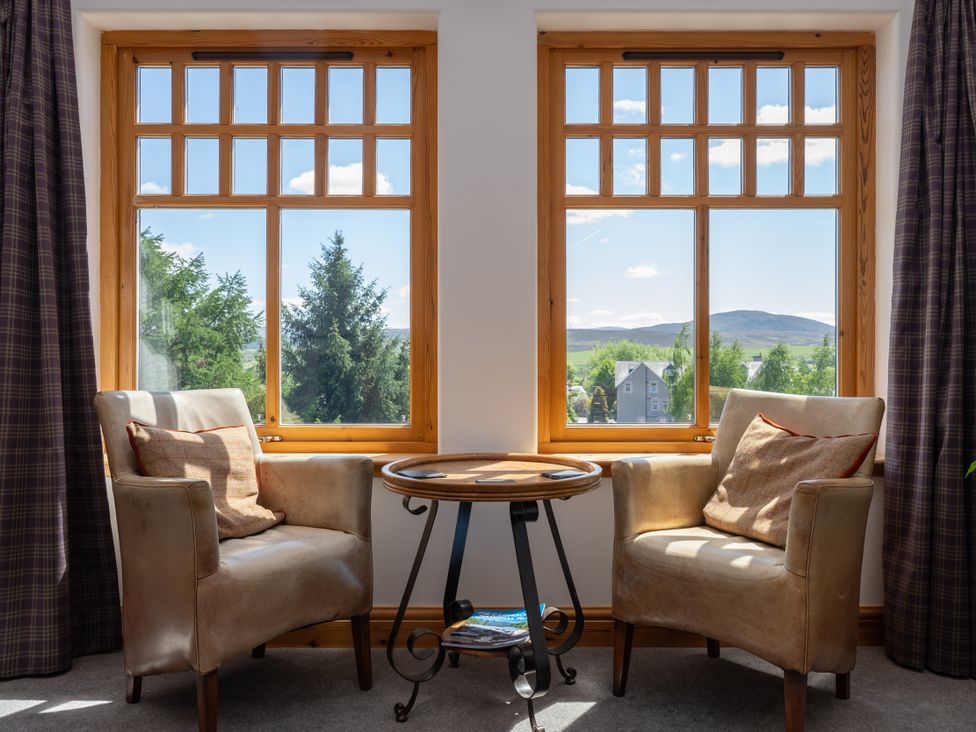 A sitting room with two chairs and a table at Old Distillery Lodge 