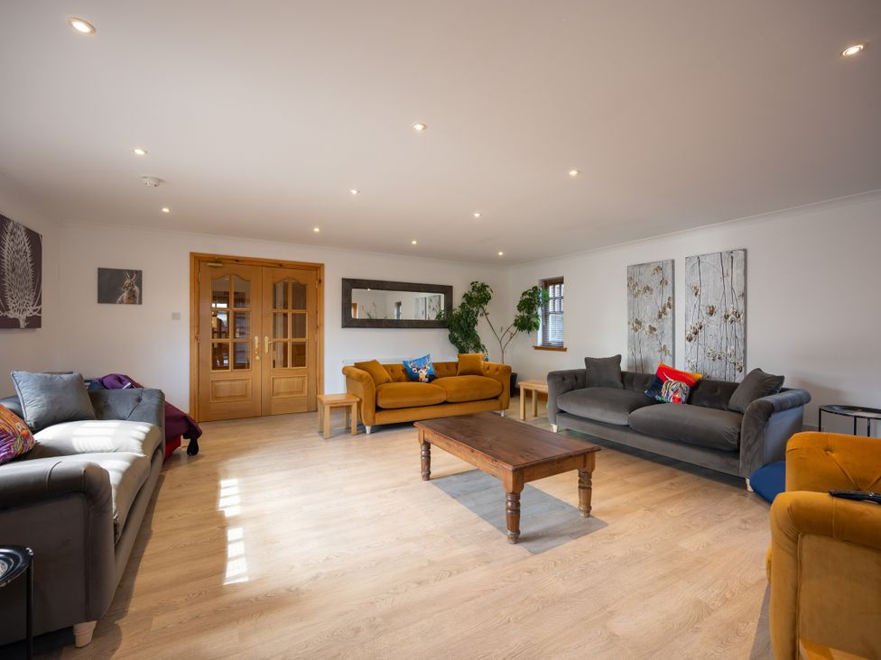 A living room with a coffee table and sofas at Old Distillery Lodge